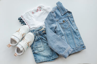 Children's stylish outfit top view, sneakers, jeans and jacket.