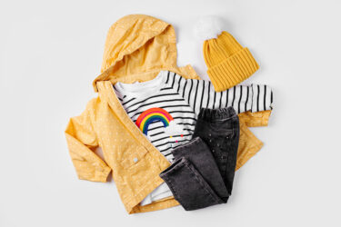 Yellow jacket, jeans and jumper on white background. Set of children's clothes for autumn. Fashion kids outfit.